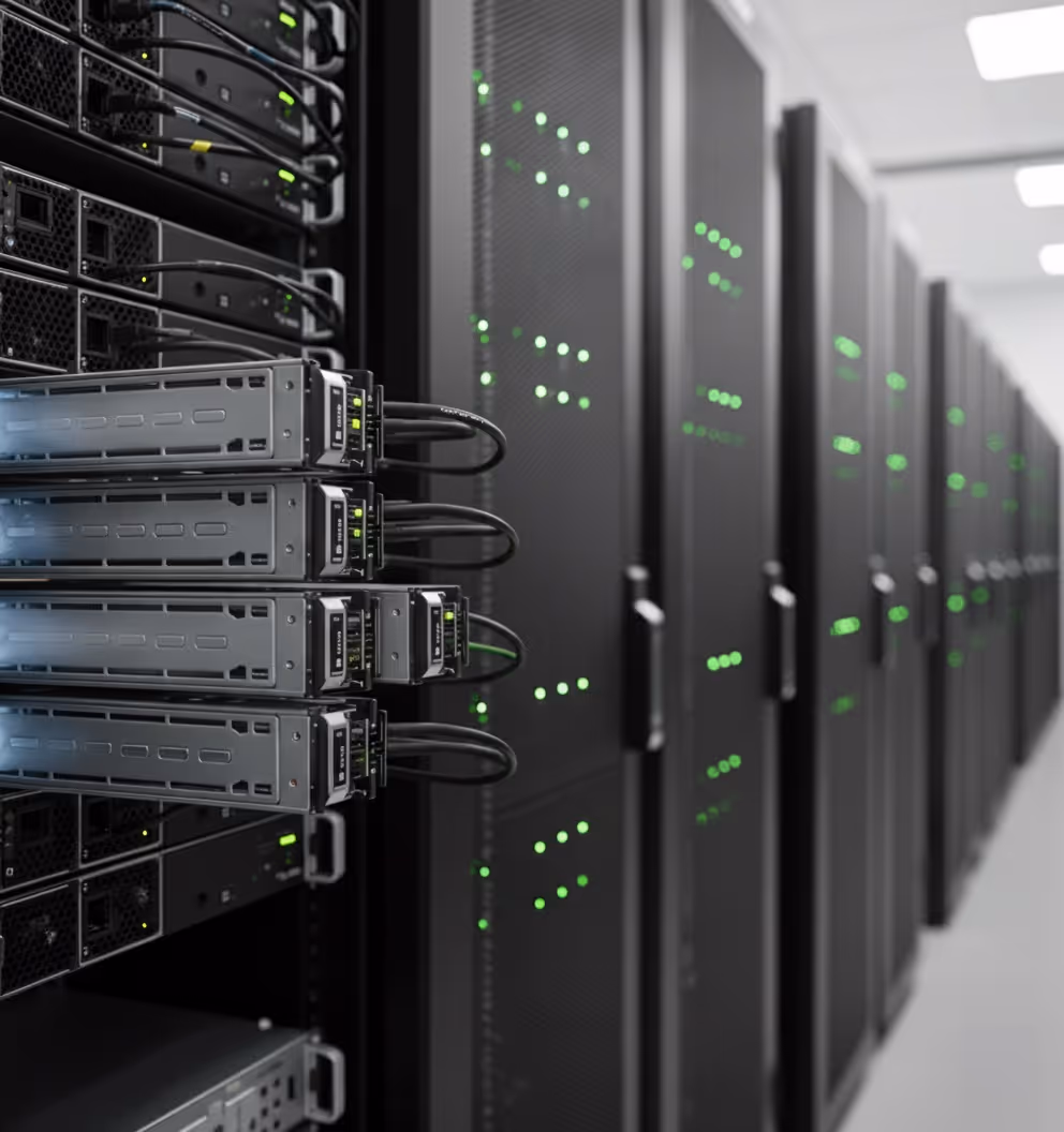 Close-up of server racks with connected network cables and green status lights in a data center.