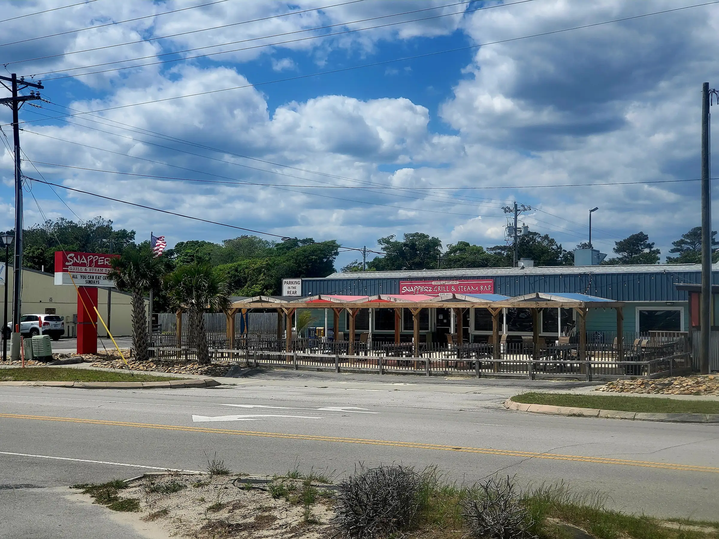 A restaurant with a red roof and a white sign.