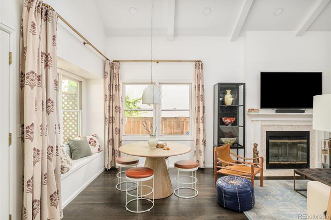 Cozy breakfast nook with round dining table and natural light in a Hilltop Denver home remodel.