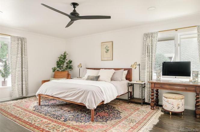 Primary bedroom remodel with minimalist design, natural light, and modern ceiling fan showcasing Denver Dream Builders’ craftsmanship.