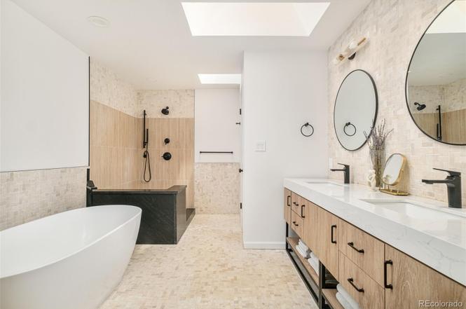 Bathroom remodel featuring a soaking tub, walk-in shower, and wood vanity for a clean modern look.