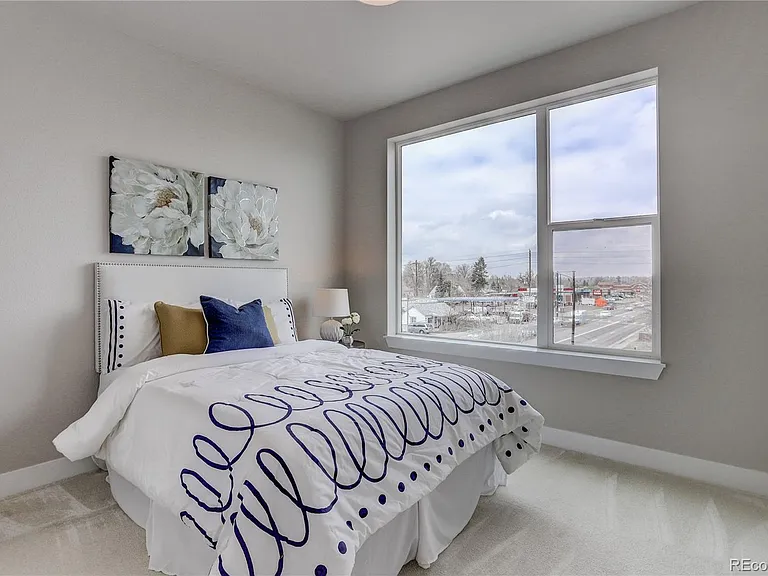 Kid’s room with playful bedding and mountain views through large window