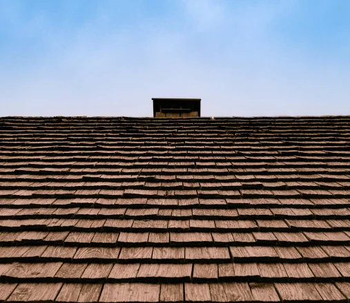 Close-up of composite shake tiles that mimic the look of a natural cedar shake roof