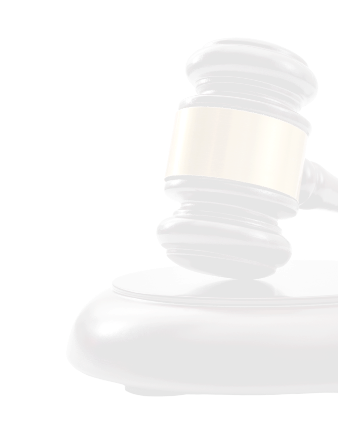 Close-up of a dark wooden judge's gavel with a brass band resting on a wooden base.