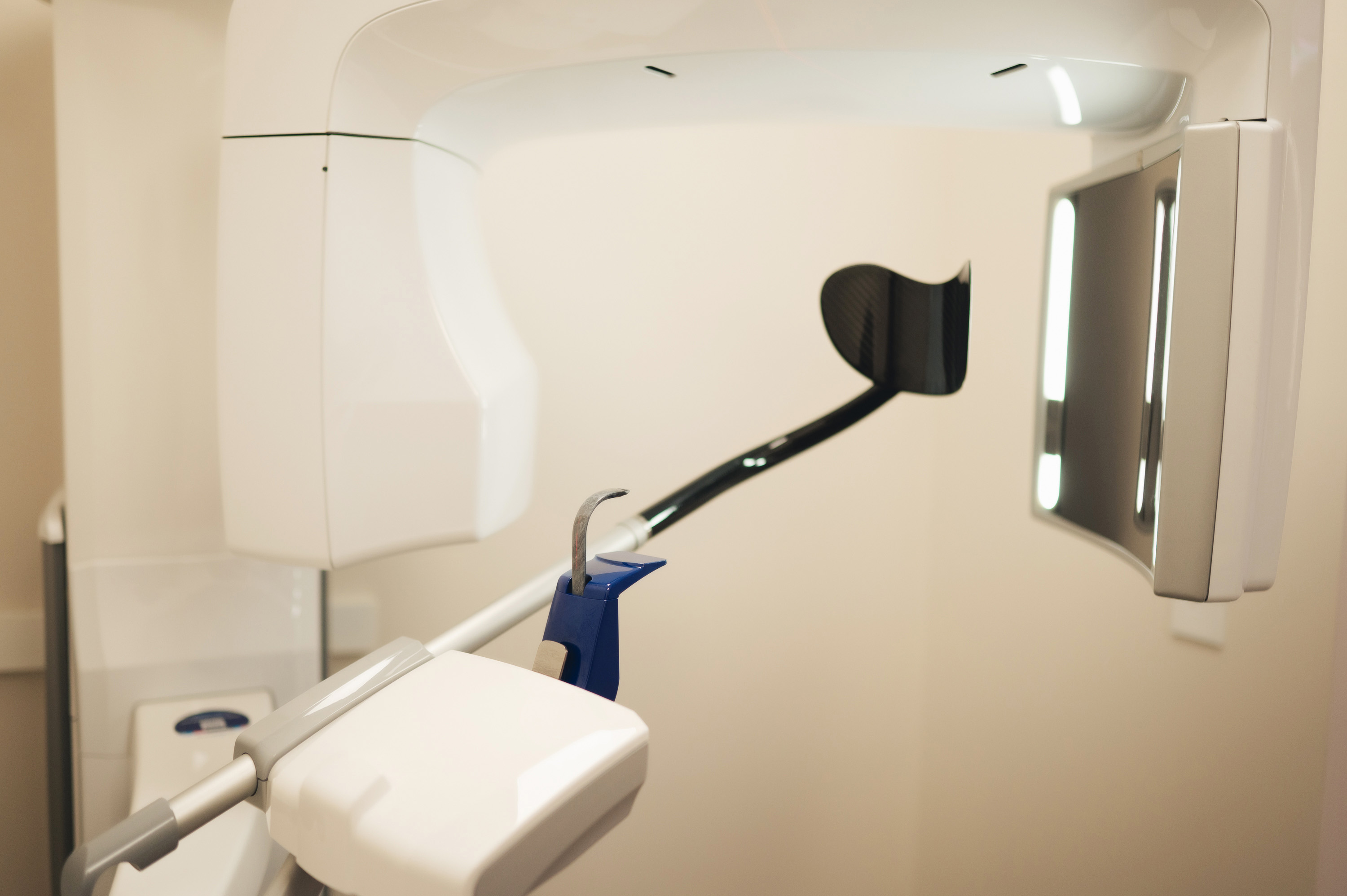 Close-up of a panoramic dental X-ray machine in a clinical setting.