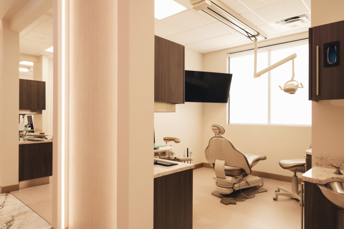 Modern dental treatment room with contemporary equipment and comfortable patient chair