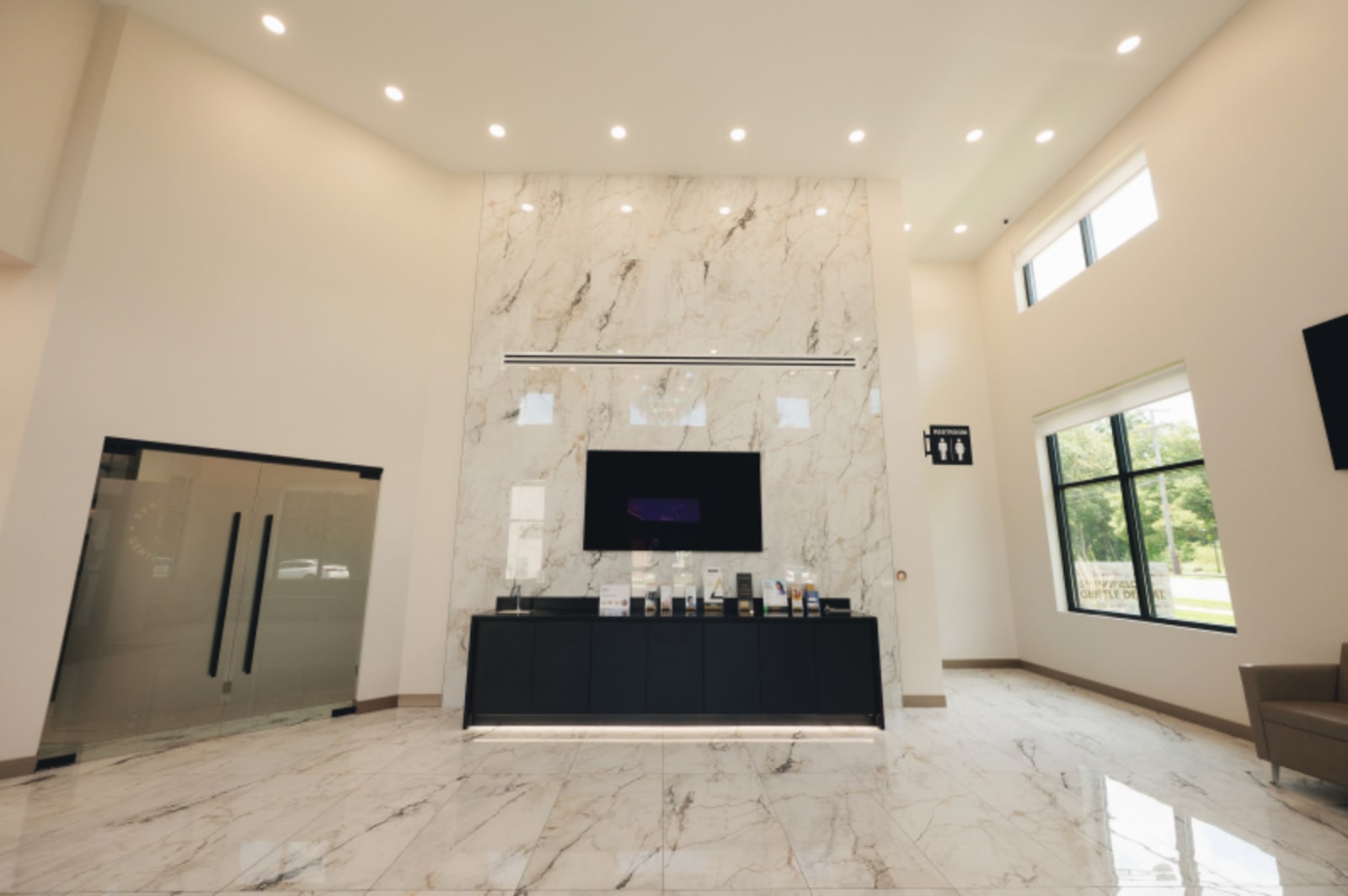 Bright, modern dental practice reception and waiting area with professional team