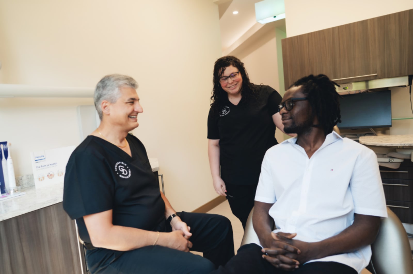 Dentist explaining procedure steps to patient during consultation appointment