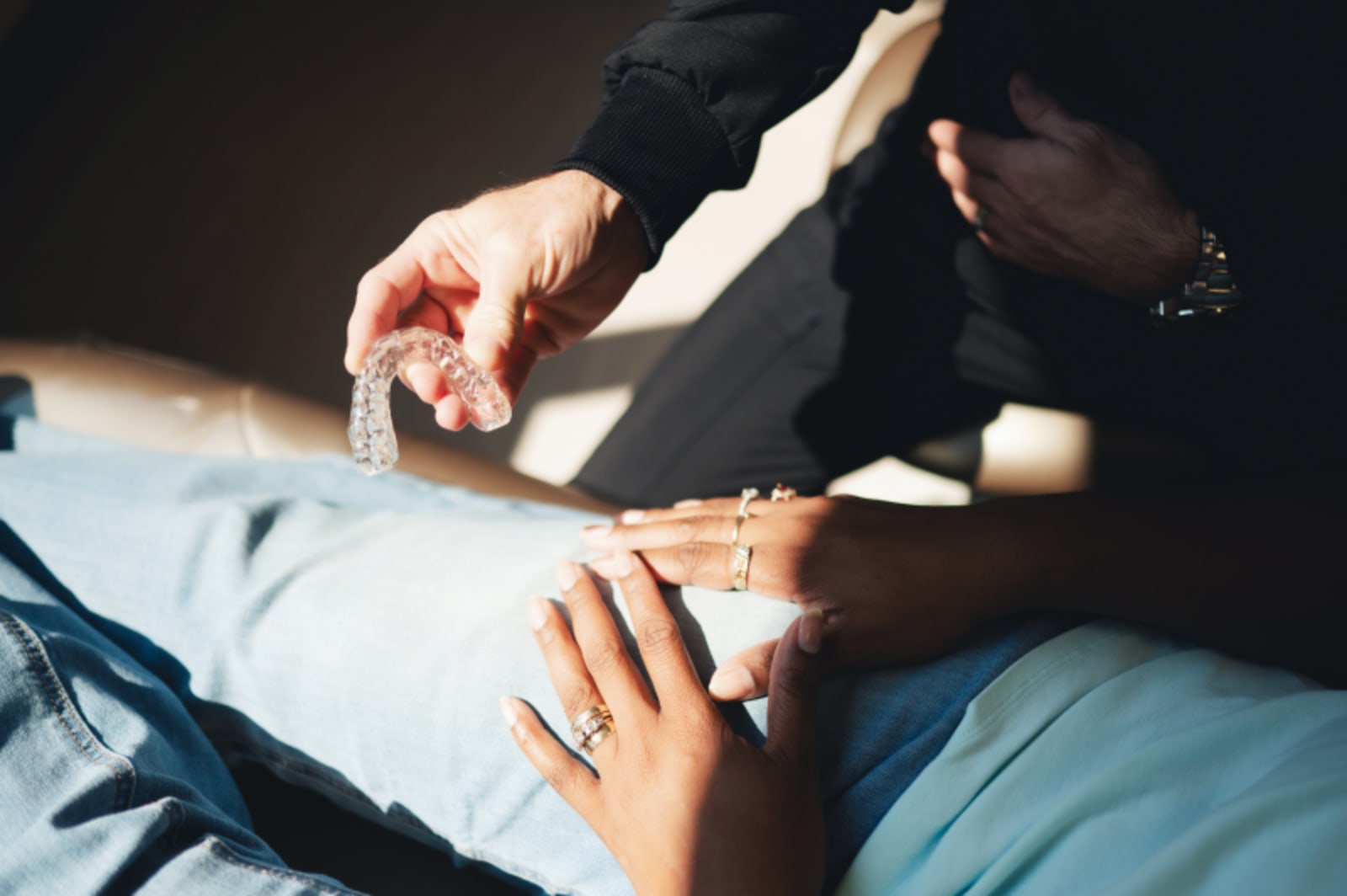 Dentist demonstrating surgical procedure on patient model with hands-on instruction