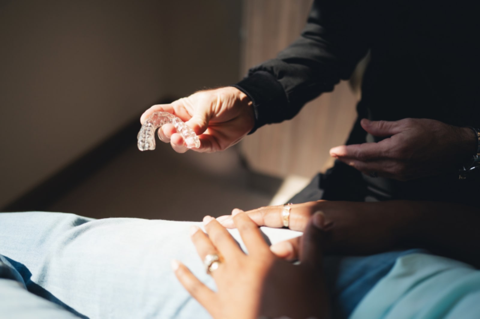 Dentist and patient discussing treatment during consultation in treatment room