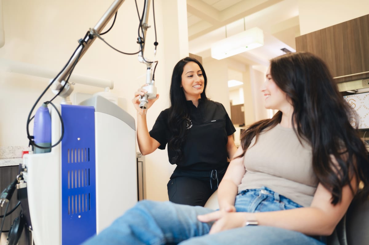 Dentist examining patient in clinical operatory with dental equipment