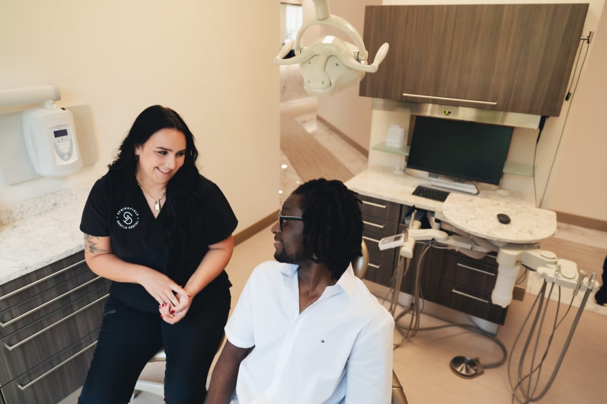 Dentist discussing treatment options with patient in clinical setting