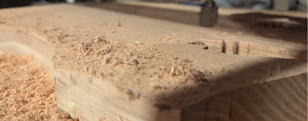 rough guitar body shape being cut on a homemade CNC machine