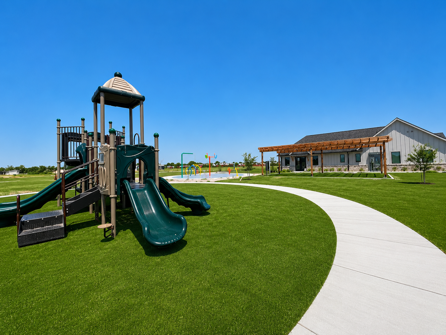 Children's playground at Lakeway Village in Princeton, TExas, featuring slides, climbing structures, and the community clubhouse in the background.