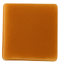 Square piece of smooth caramel fudge with a glossy surface on a white background.
