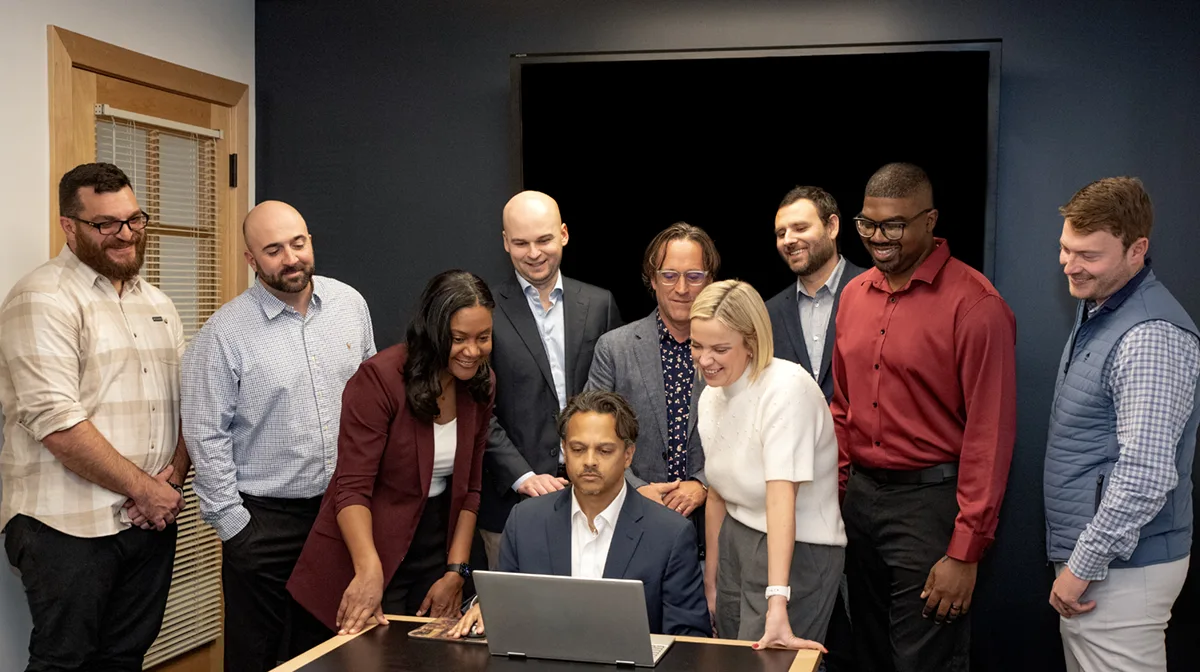 The BCS Search team looking at their new recruiting firm website in a meeting room