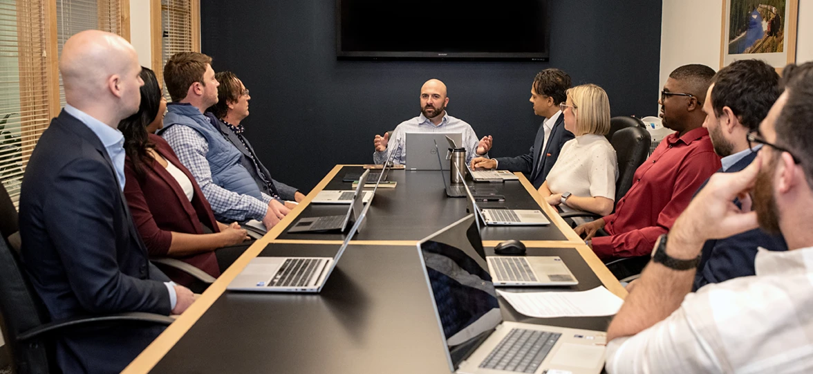 the experienced recruiters at BCS search recruiting firm sitting around a conference table