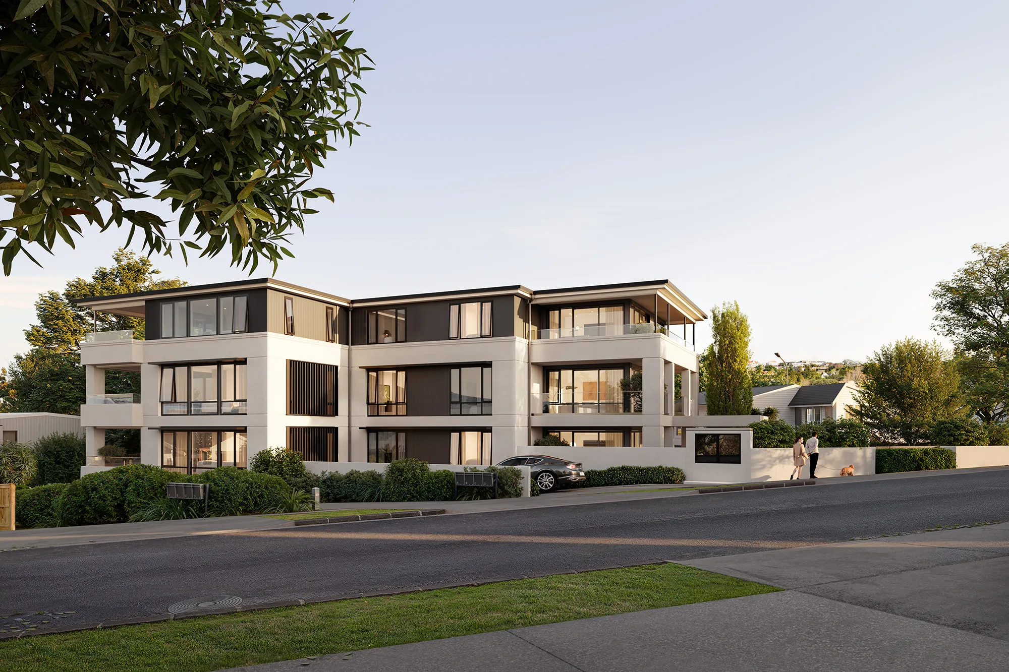 The Ternion facade, with a black car parked by the driveway, and a couple walking a small dog on the sidewalk.