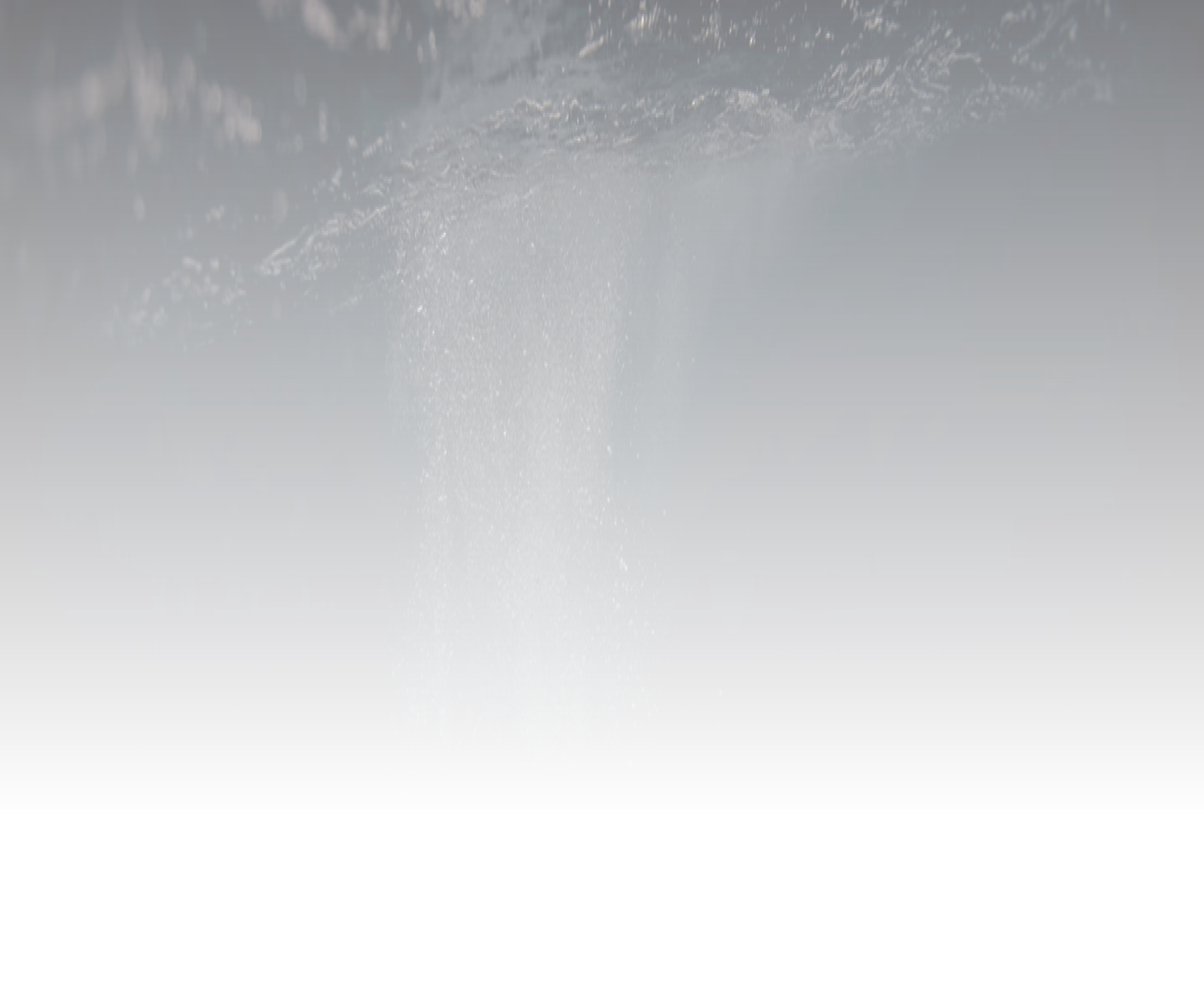 Bubbles rising underwater with a dark background and surface visible above.