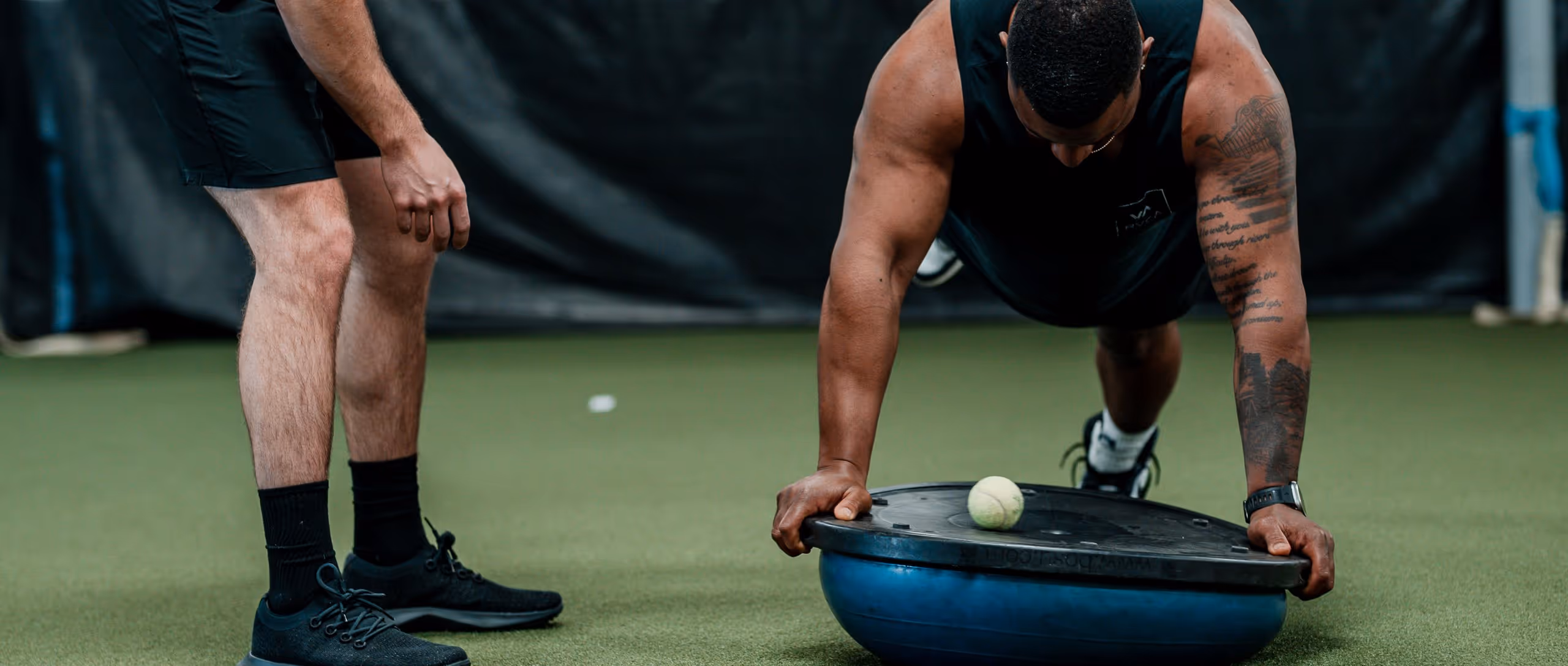 A patient performing a plank exercise with a physical therapist observing in a physical therapy clinic in Richmond, VA