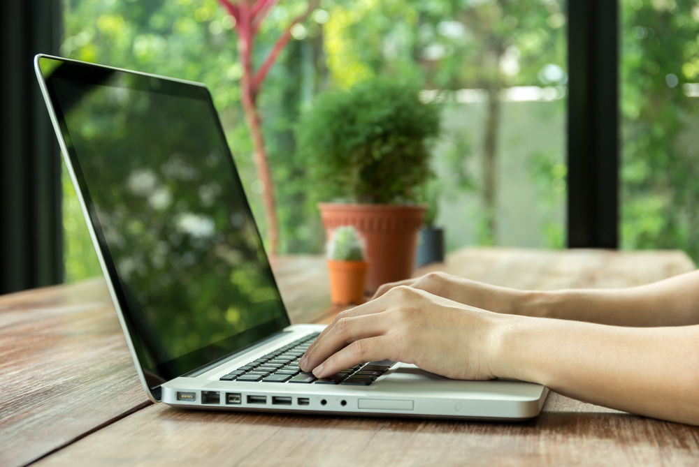 An operations leader working on a laptop, turning strategy into owned commitments