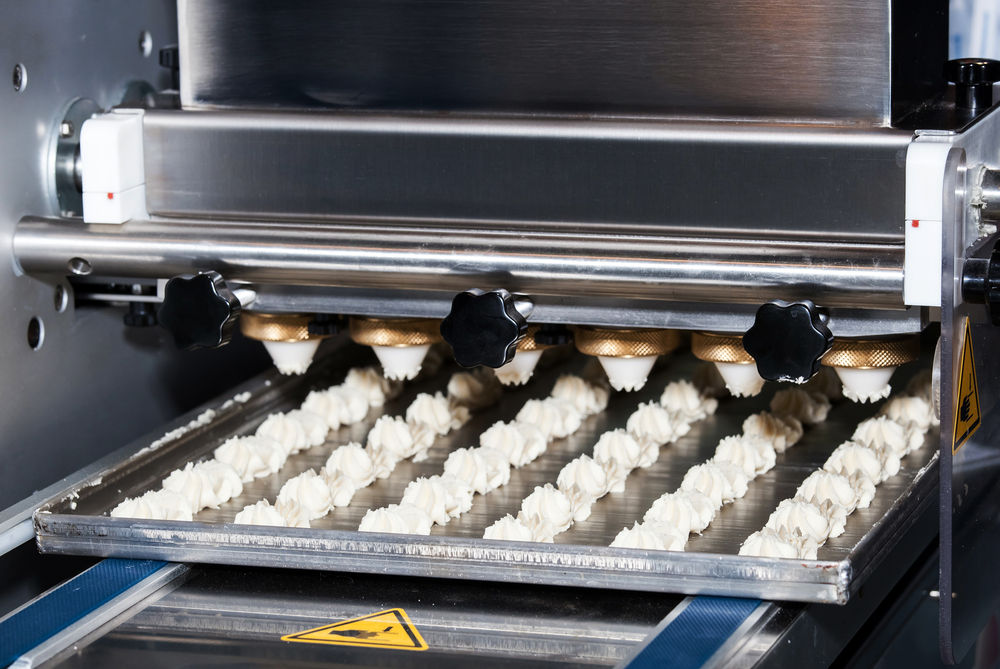 Automated depositing machine on a bakery production line — automation meeting real production work
