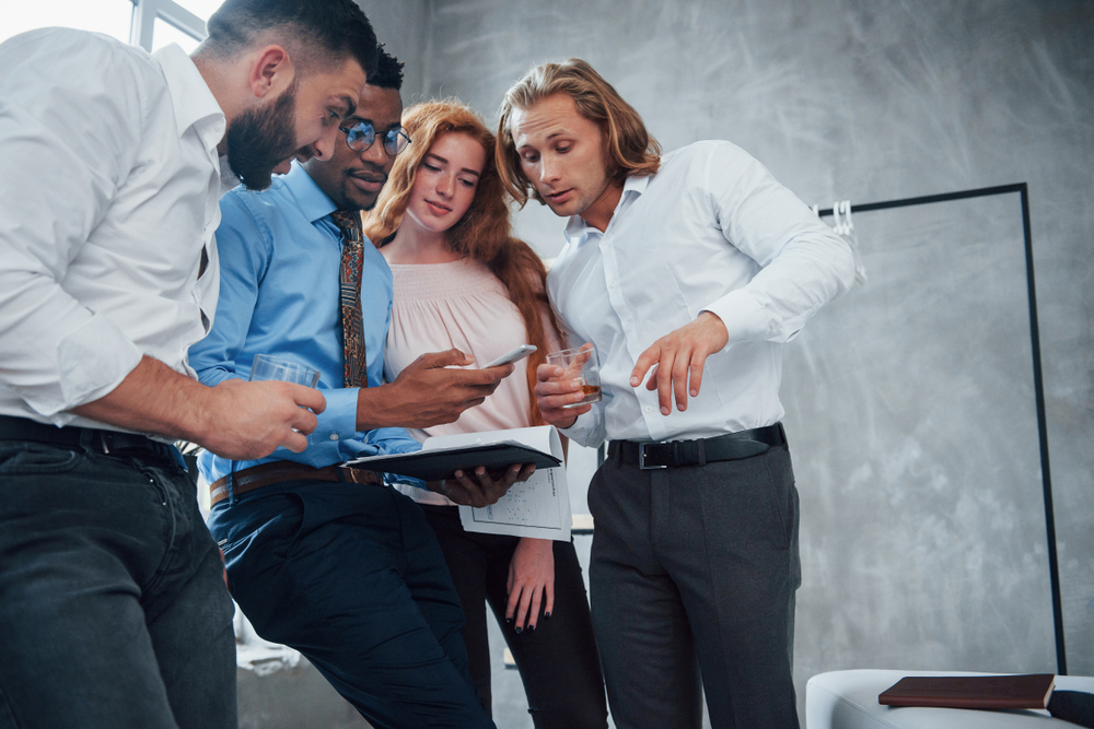A team gathered around a document working through an operational decision