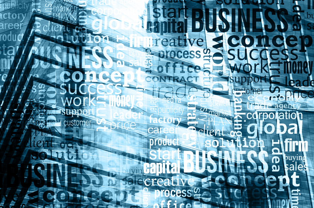 Business strategy concept words layered over a glass office building