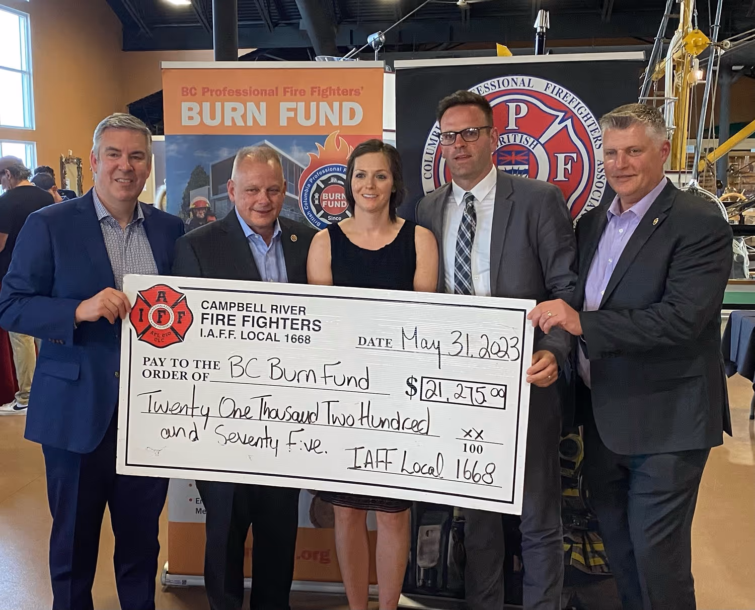 Campbell River Fire Fighters Union members presenting a $21,275 check to the BC Burn Fund during a community event.