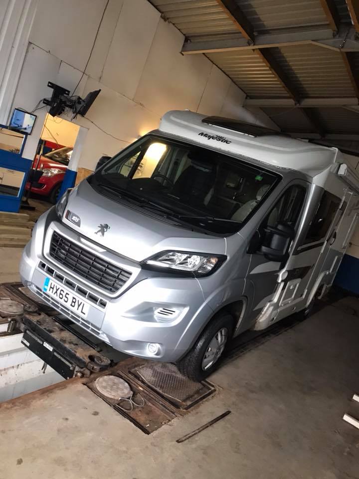 A motorhome inside an MOT bay