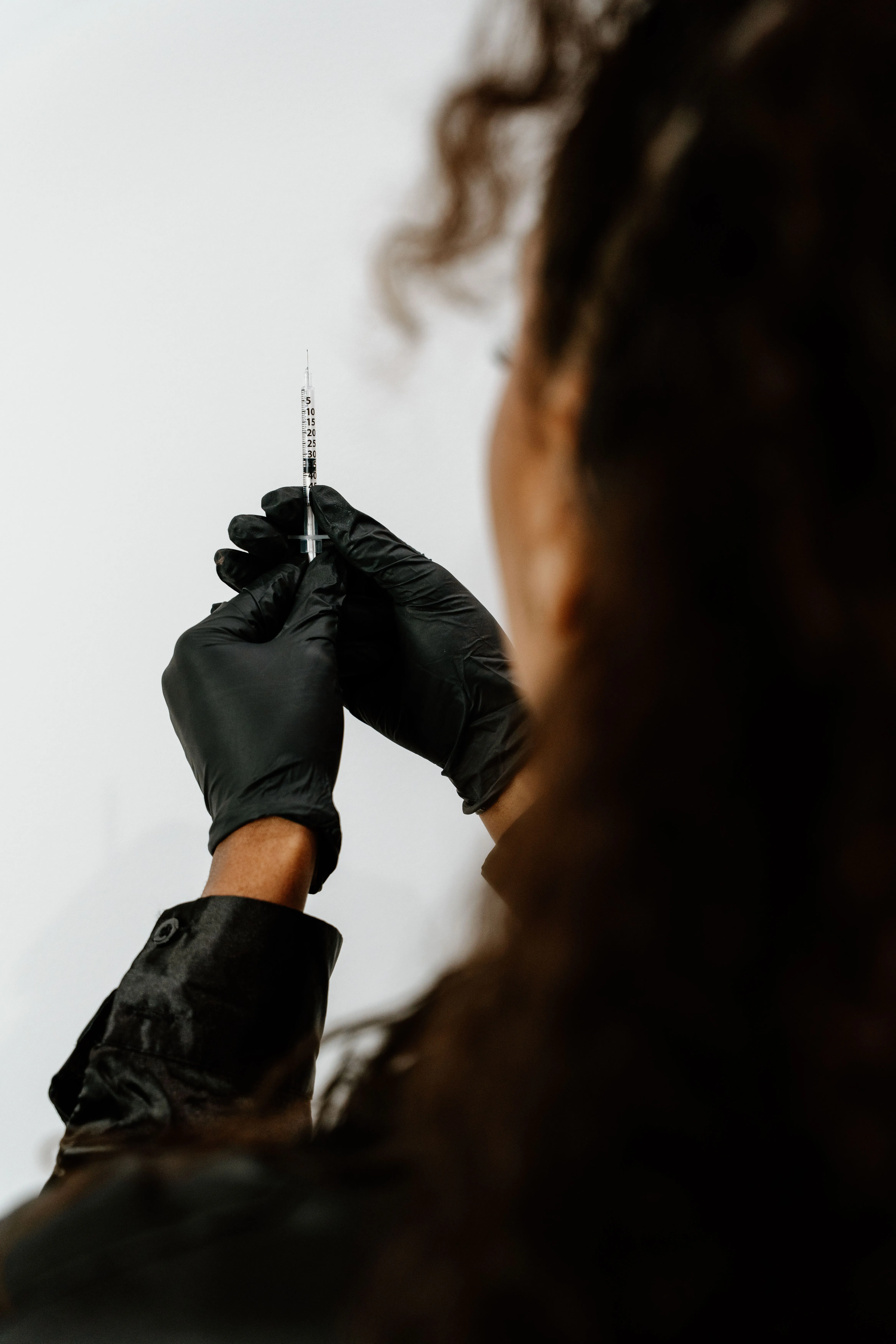 Gloved provider preparing a wellness injection at Bonita Aesthetics