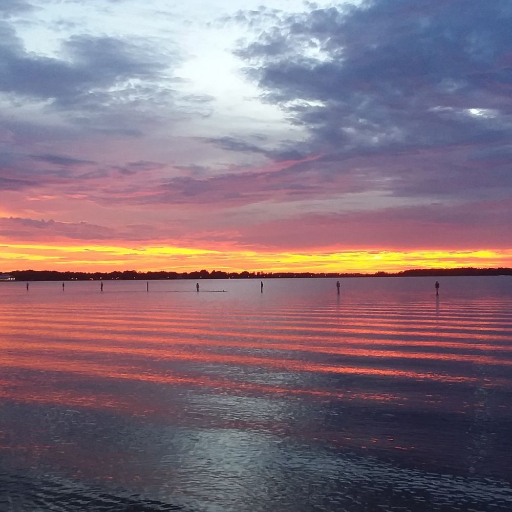 Pink and orange sunset over calm water in Minneola, Florida