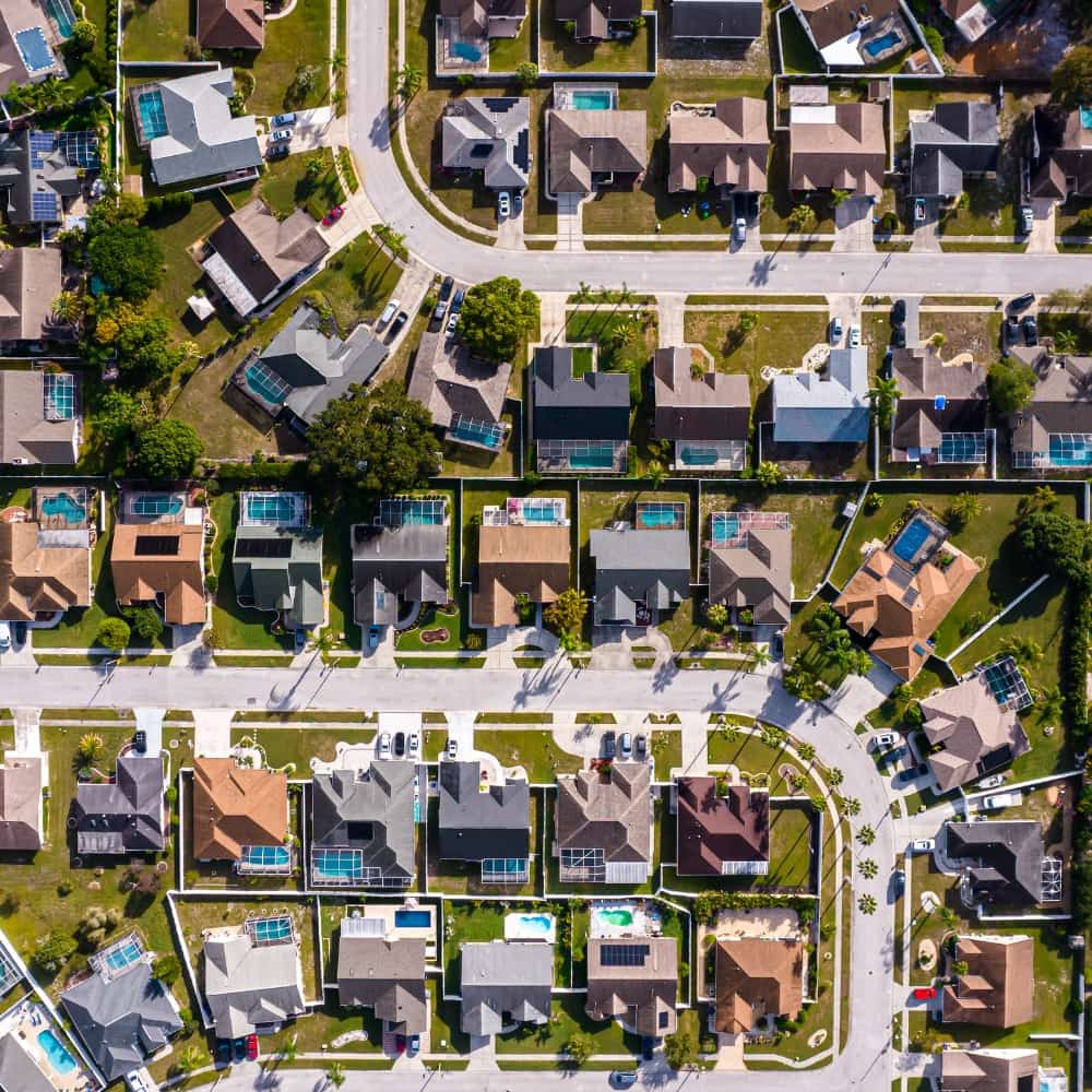 Quiet residential street lined with oak trees in Central Florida.