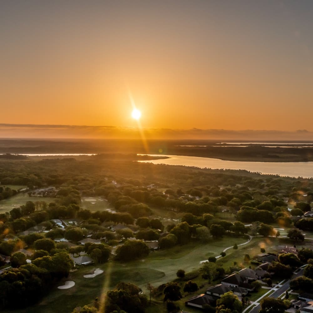 Aerial view of a Florida community and a wide lake at sunrise