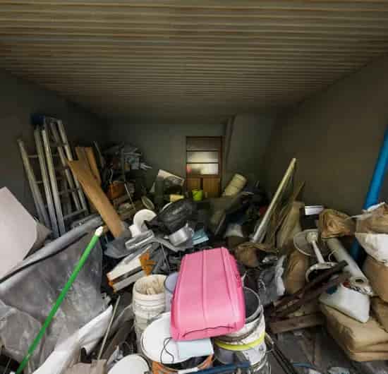 Garage packed with old junk and debris waiting to be hauled away