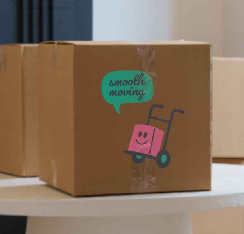 Sealed cardboard box with a moving sticker, packed and ready to go
