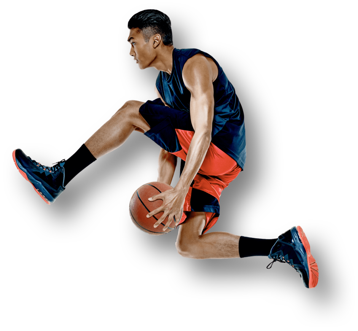 A basketball player in the air passing a basket ball between his legs