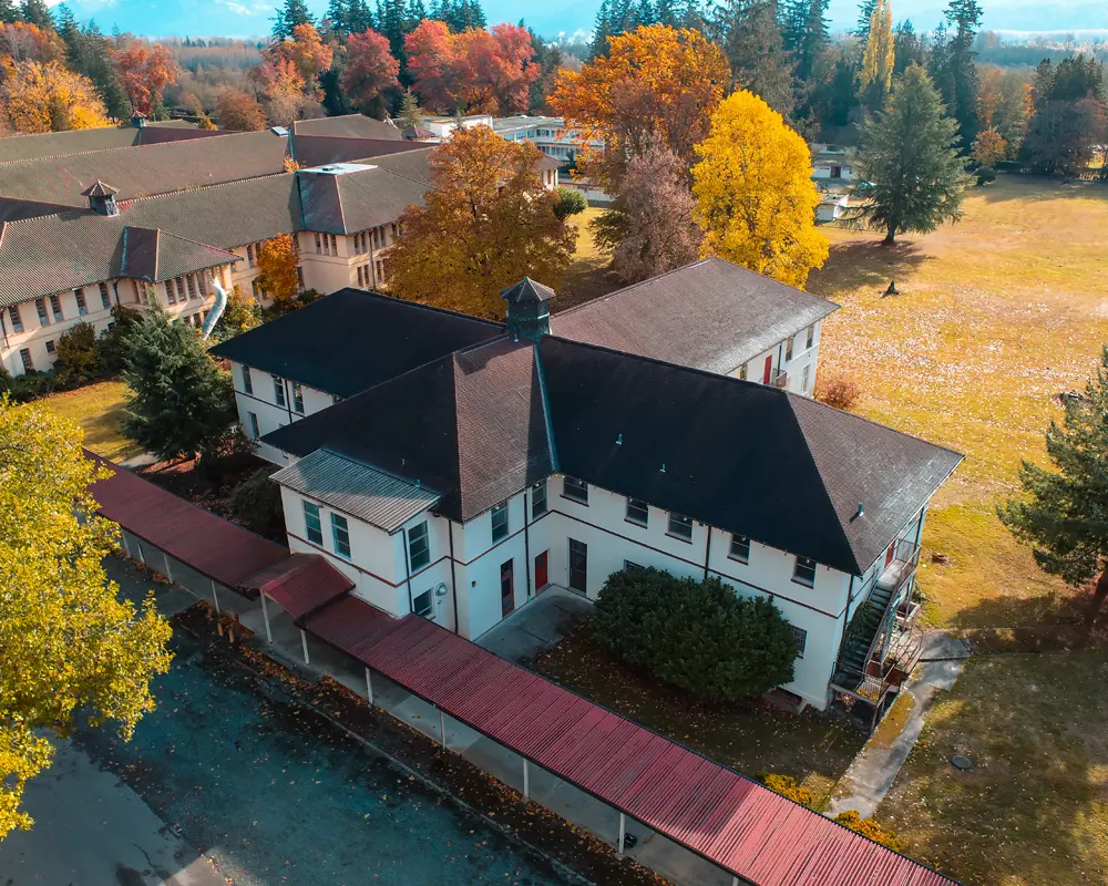SWIFT Center the Colman Building aerial view of a spanish colonial revival building built in 1915 surrounded by trees in fall color