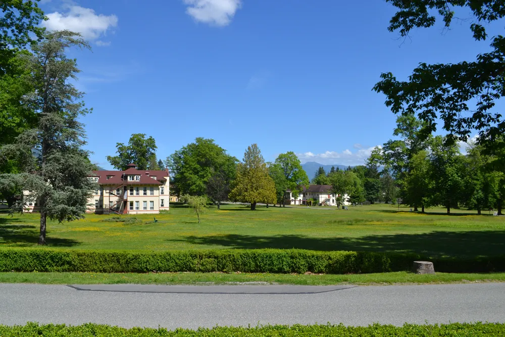 adaptive reuse opportunity swift center park like campus with wide expand of grass, trees, mountains in the background and blue skies overhead