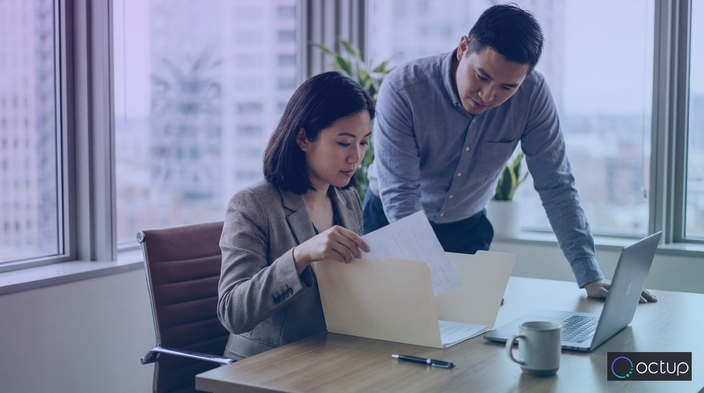 A 3PL sales professional assembling a fulfillment services proposal at an office desk.