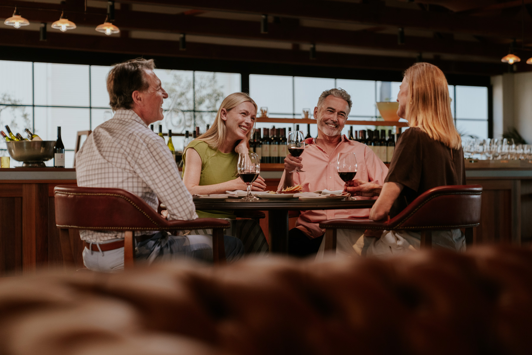 friends around a table at a winery drinking red wine
