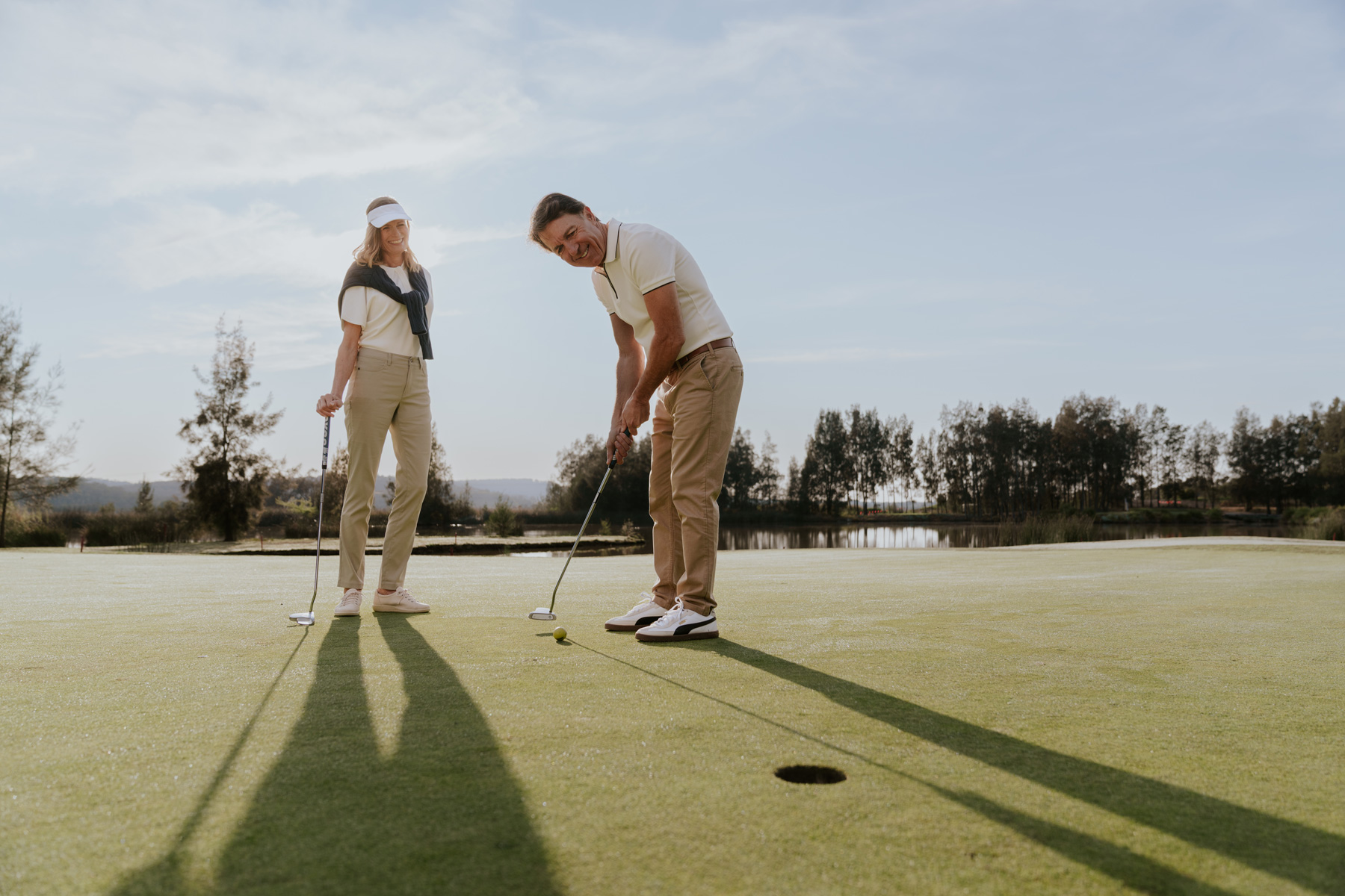 couple putting at golf course
