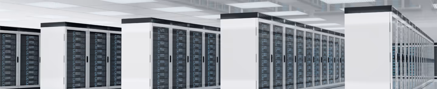 Rows of white server racks filled with black network equipment in a modern data center.