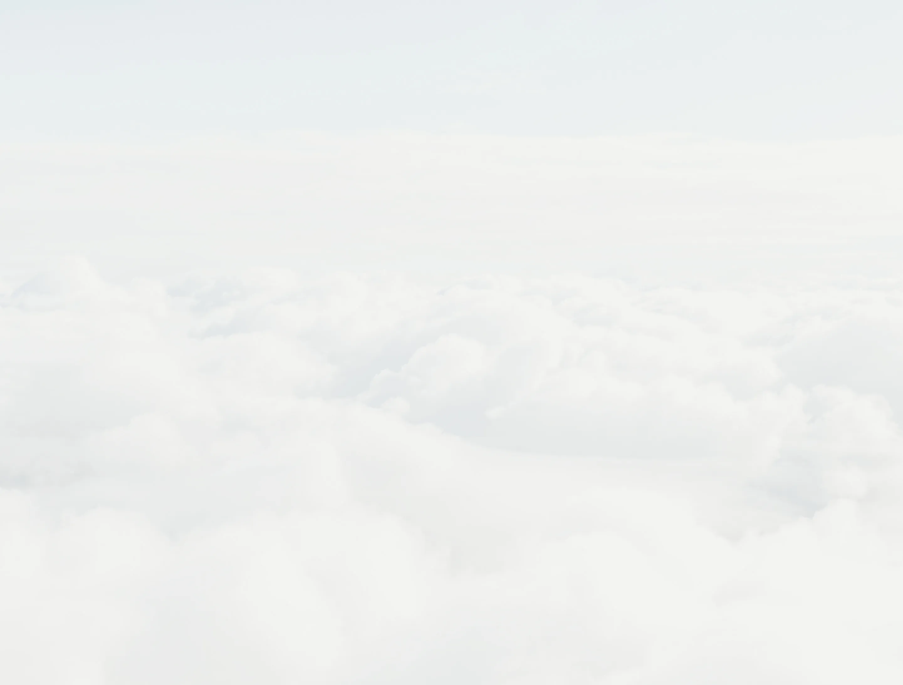 Vue aérienne de nuages blancs denses sous un ciel clair.