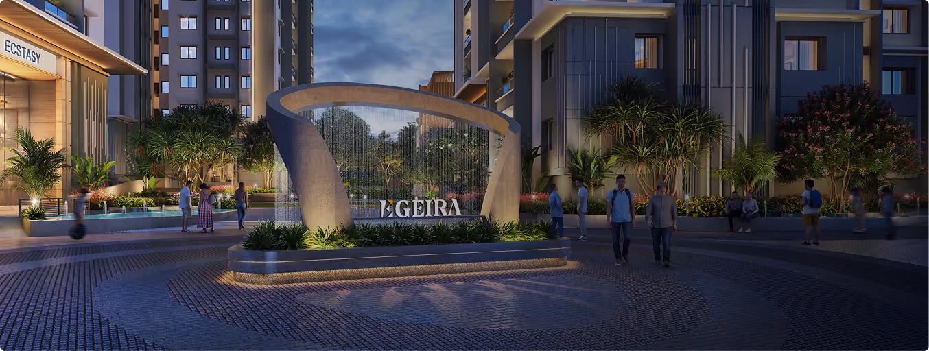 Evening view of modern apartment complex courtyard with a curved fountain and people walking.