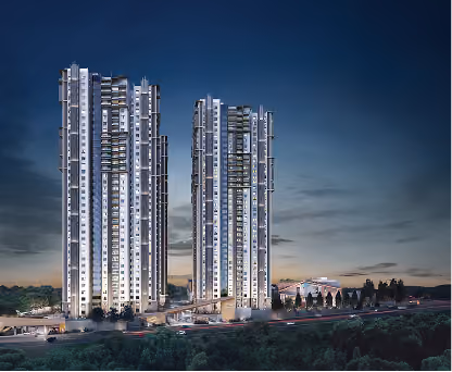 Two illuminated modern high-rise buildings at dusk with surrounding landscape and roads.