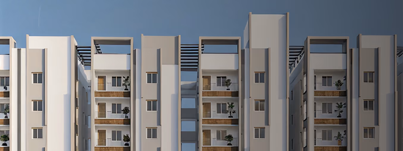 Modern multi-story apartment building with balconies and plants against a clear blue sky.