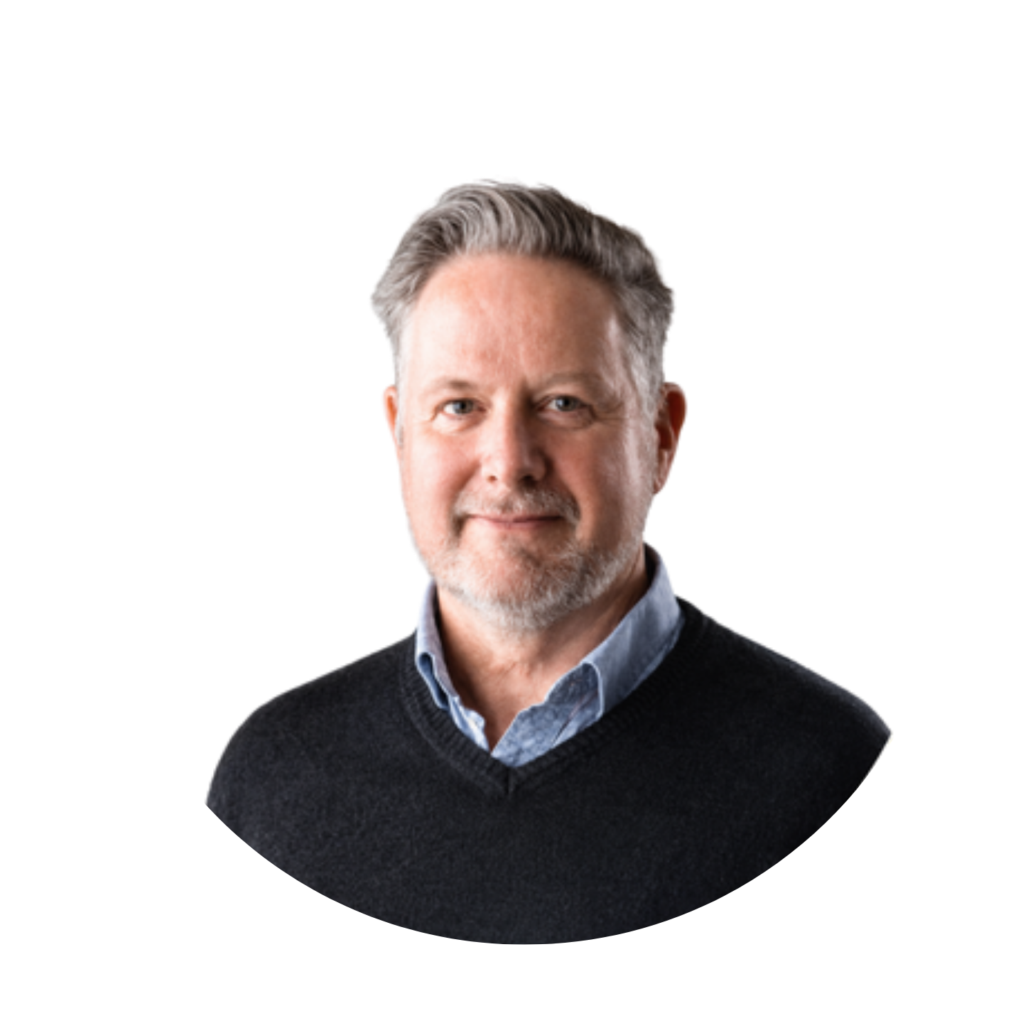Middle-aged man with gray hair and beard wearing a black sweater and blue shirt, smiling slightly.