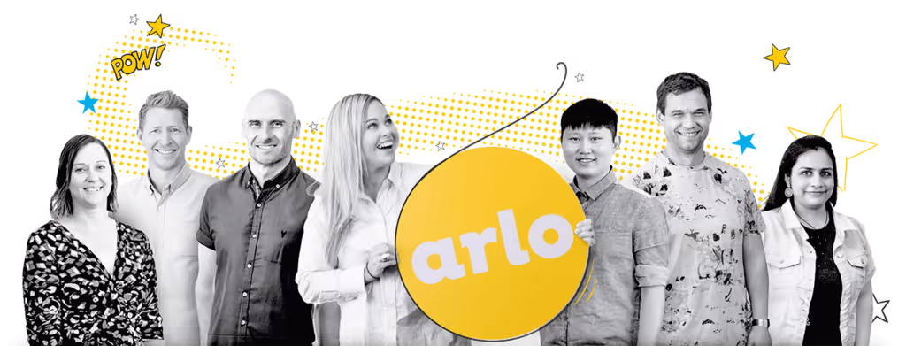 Arlo's support team holding an Arlo logo sign