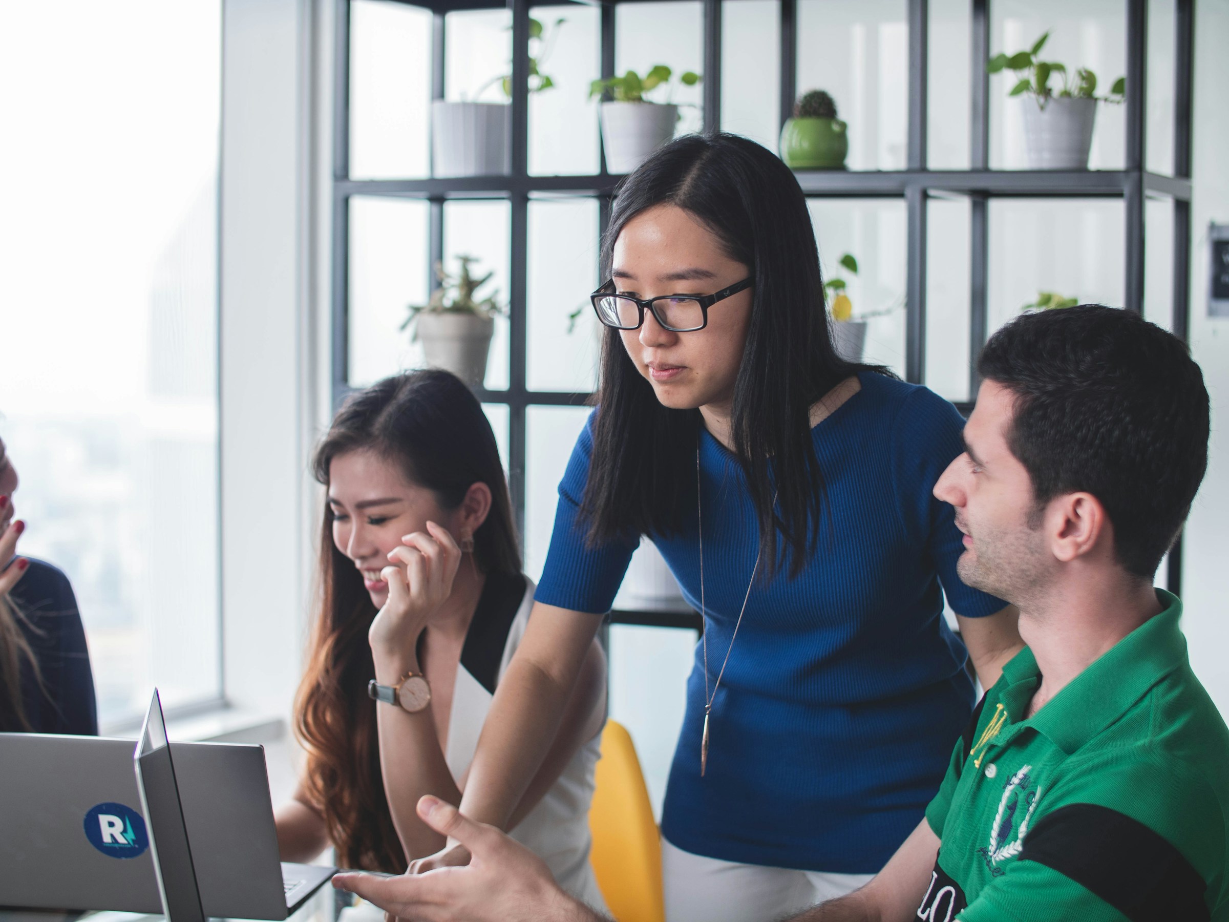 employees working on a laptop - Forex Prop Firms